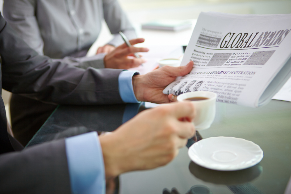 close-up-executive-with-coffee-newspaper